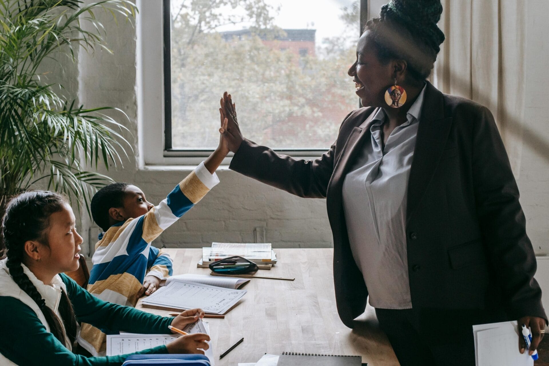 Teacher high fiving a child